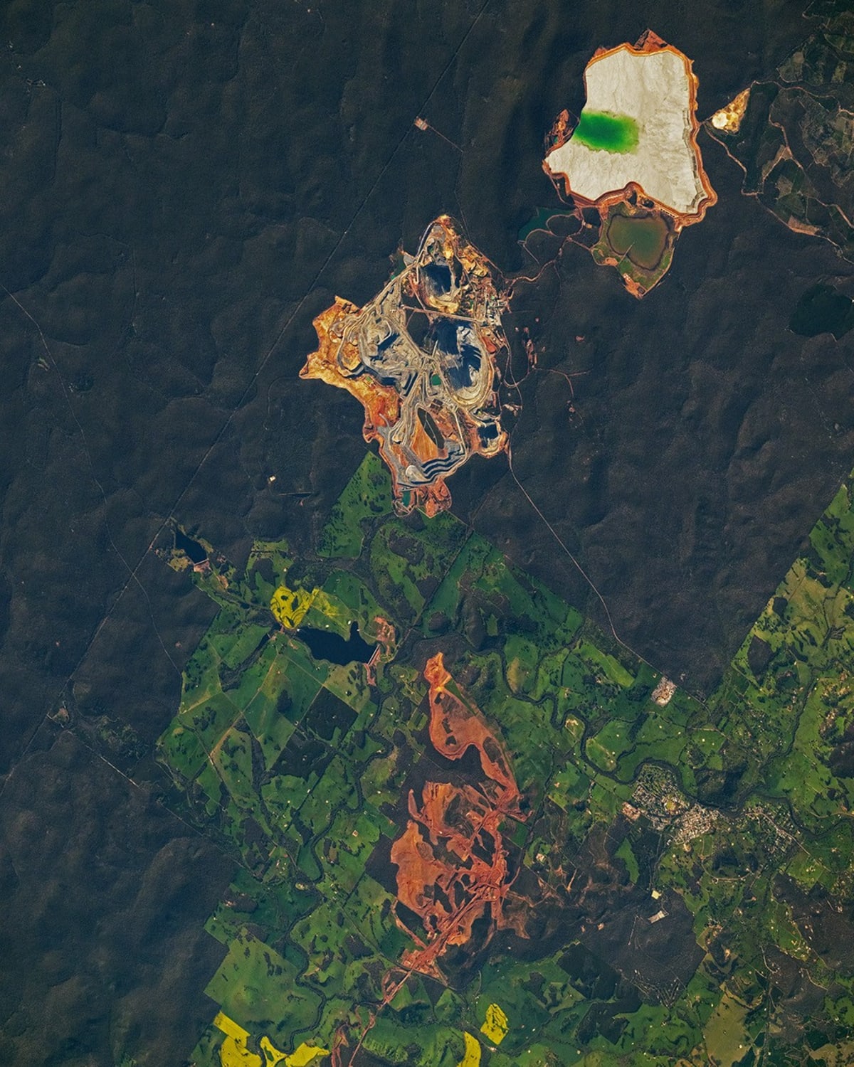 Satellite view of abandoned mine sites with mineral waste visible from space orbit
