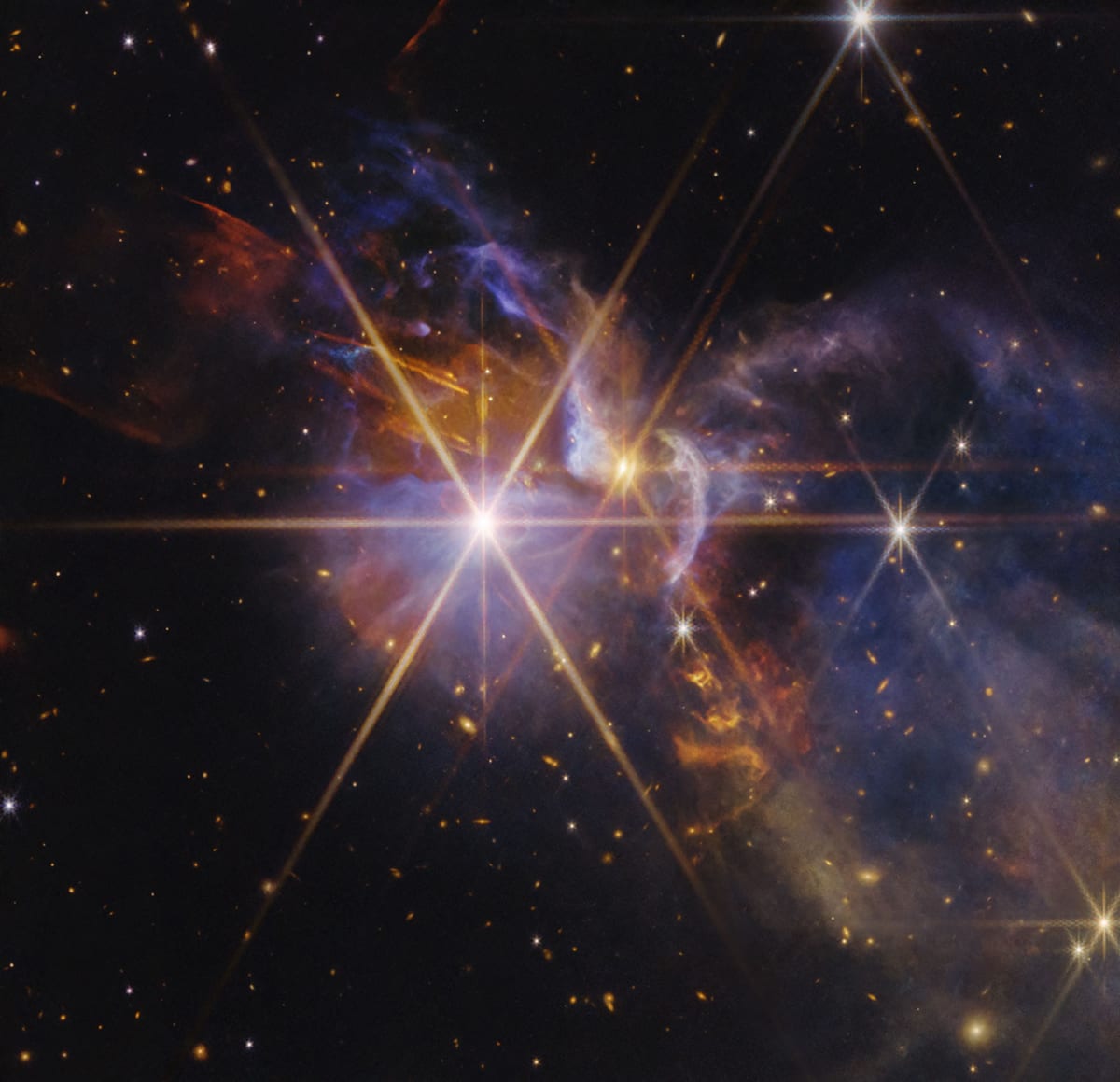 Infrared image showing orange baby stars and bright outflows in FS Tau system captured by Webb Telescope