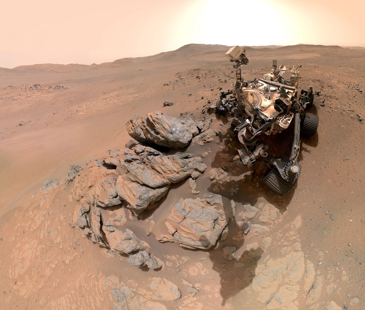 NASA Perseverance rover selfie on Mars showing robotic arm and western crater rim background