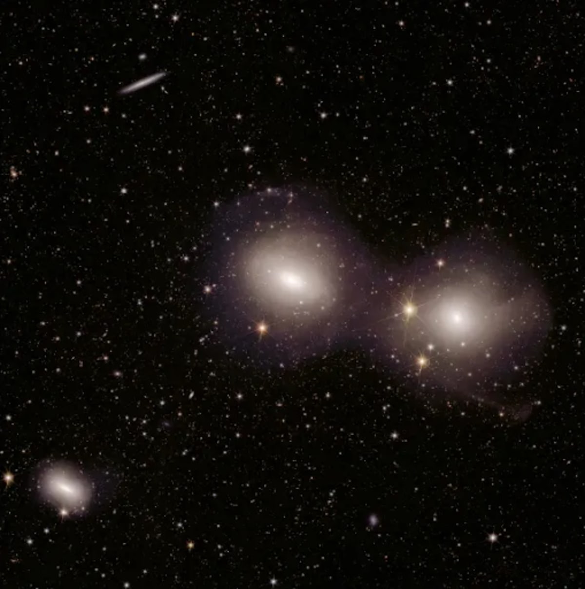 Euclid telescope view of Dorado galaxy group showing curved tails and shells from gravitational interactions