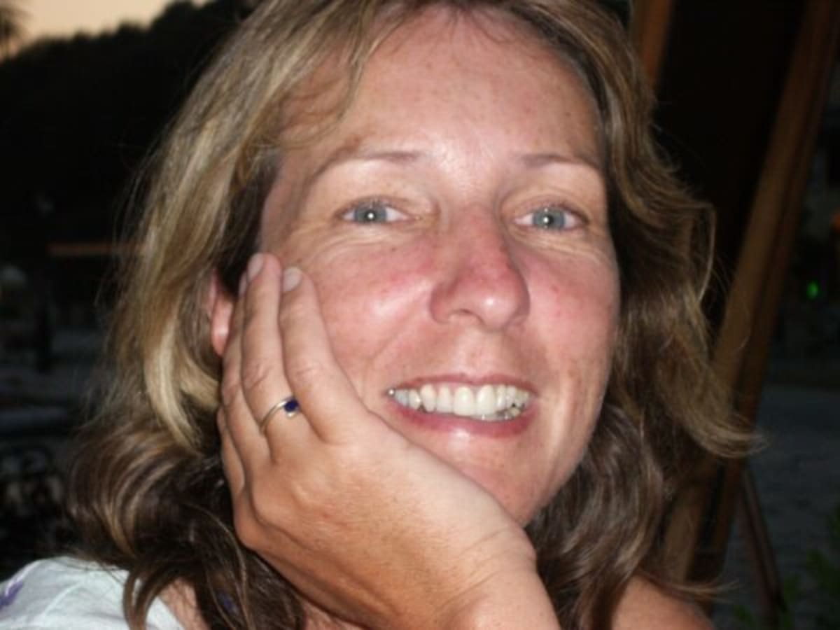 Smiling woman with family outdoors, representing Gillian Lee who inspired brain cancer research funding