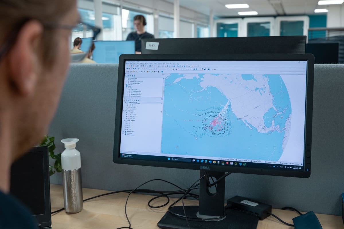 Cargo ship equipped with automated camera system scanning ocean surface for plastic debris