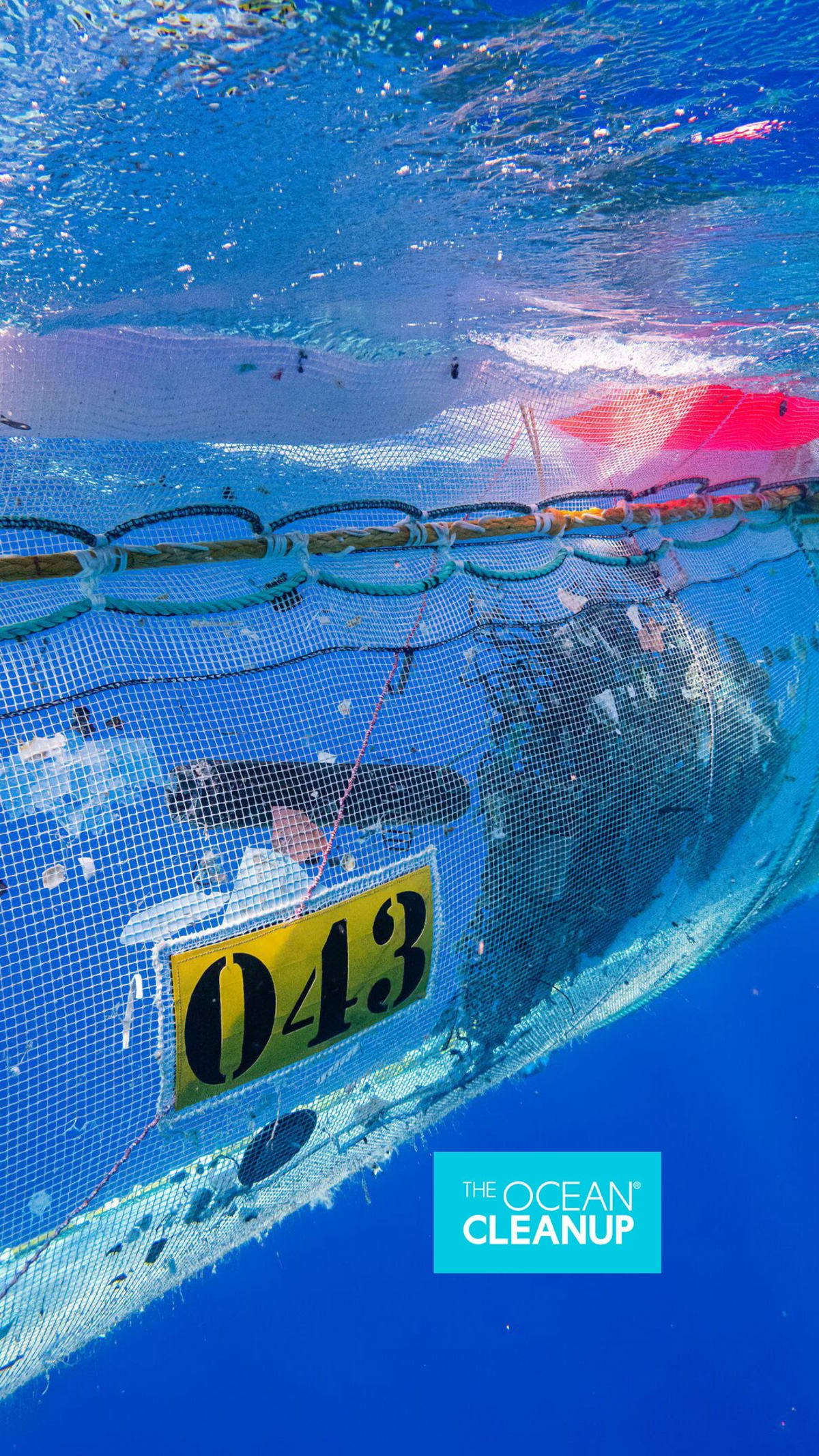 Ocean cleanup vessel with retention zone filled with collected plastic from Great Pacific Garbage Patch