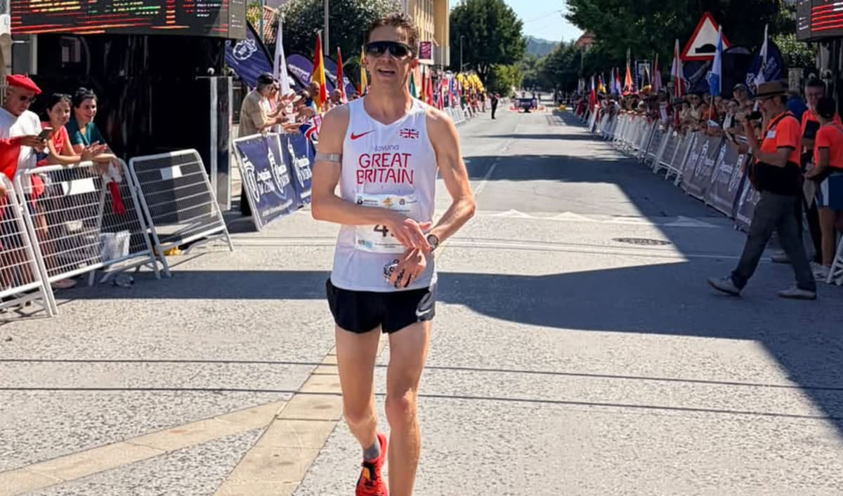 Alex Milne running on road course during 100km world championship race in Spain