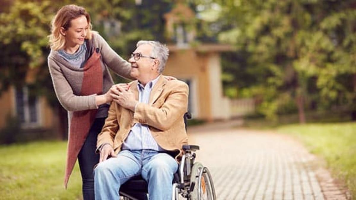 Volunteer driver helping senior citizen into vehicle for medical appointment transportation
