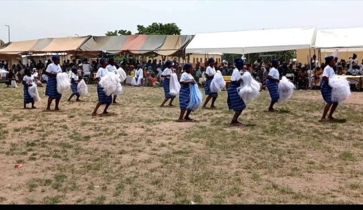 Diverse ethnic communities in colorful traditional dress dancing together at Ghana's Wa Zongo Festival