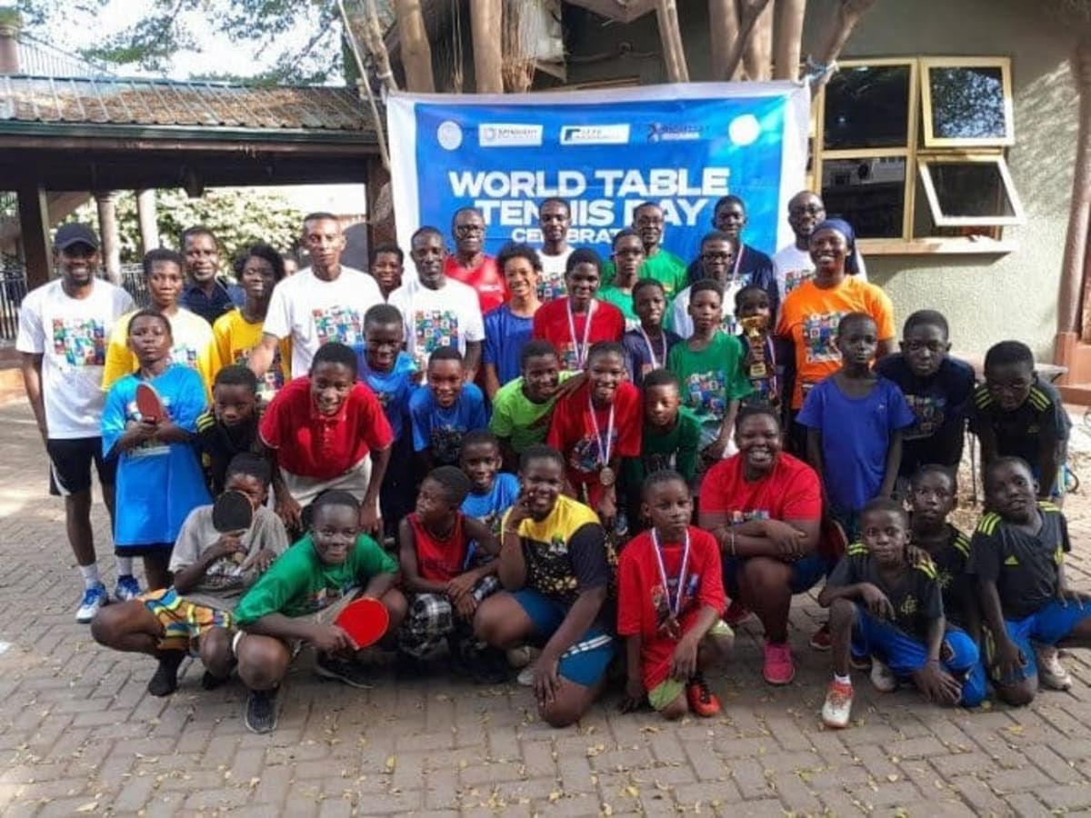Young table tennis players competing at community tournament in Accra, Ghana celebrating youth development