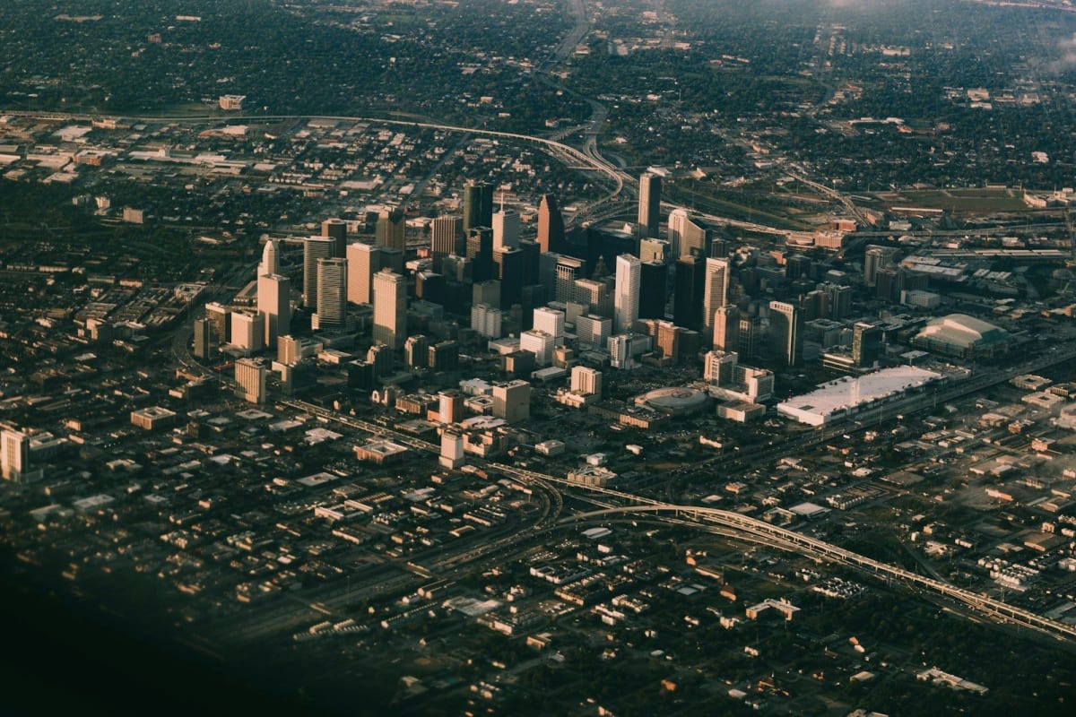Fiber optic cables glowing blue representing high-speed internet infrastructure expanding across Houston neighborhoods
