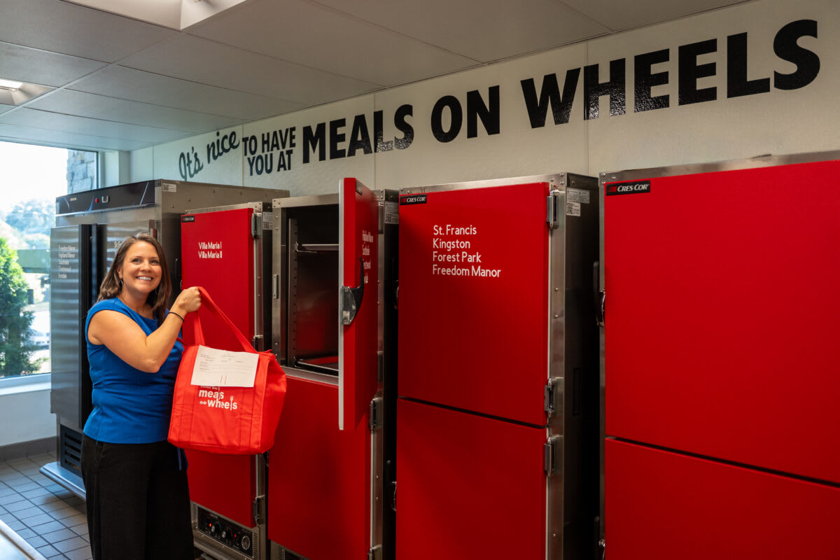 April McMaster coordinating volunteers in Meals on Wheels kitchen preparing food for Birmingham seniors