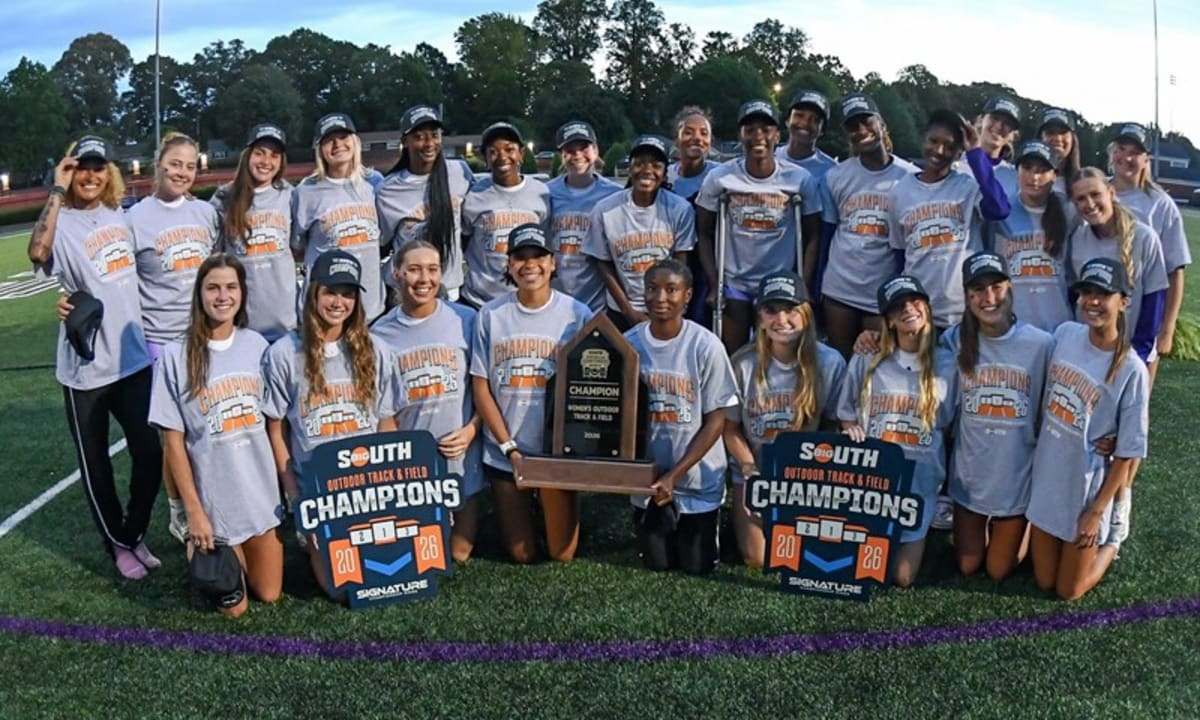 High Point University women's track athletes celebrating championship victory with raised arms on outdoor track