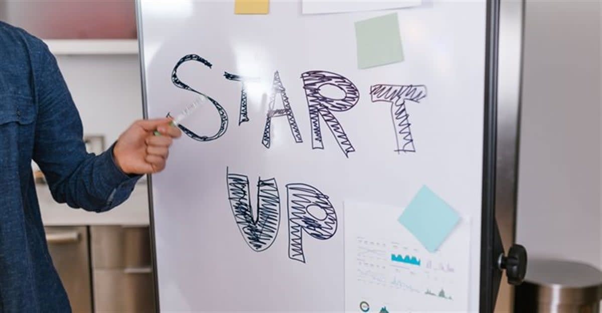 African entrepreneur presenting technology startup pitch to panel of international judges and investors