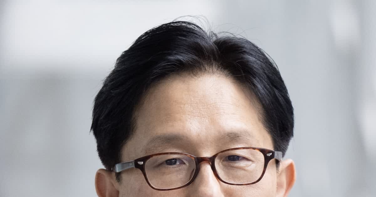 Professor Kim Dong-ha in laboratory examining colorful light-emitting materials on research equipment