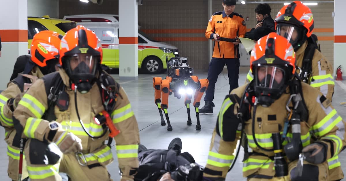 AI quadruped robot conducting search and rescue training drill at Seoul Fire Academy training facility