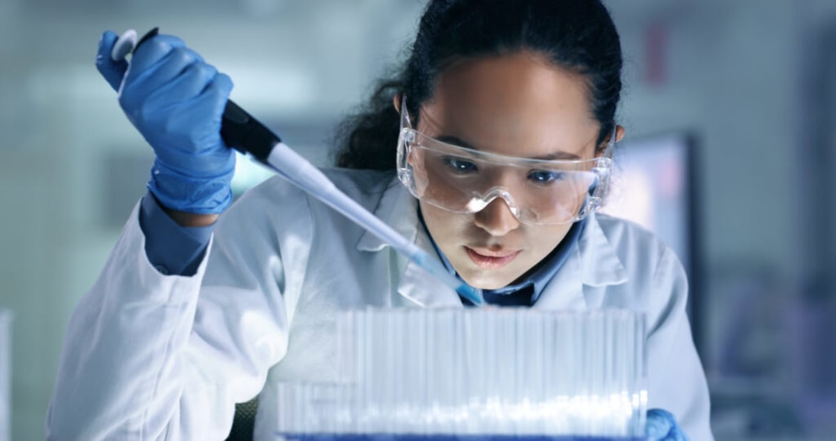 Scientists working with advanced computer systems in modern research laboratory with Microsoft technology displays