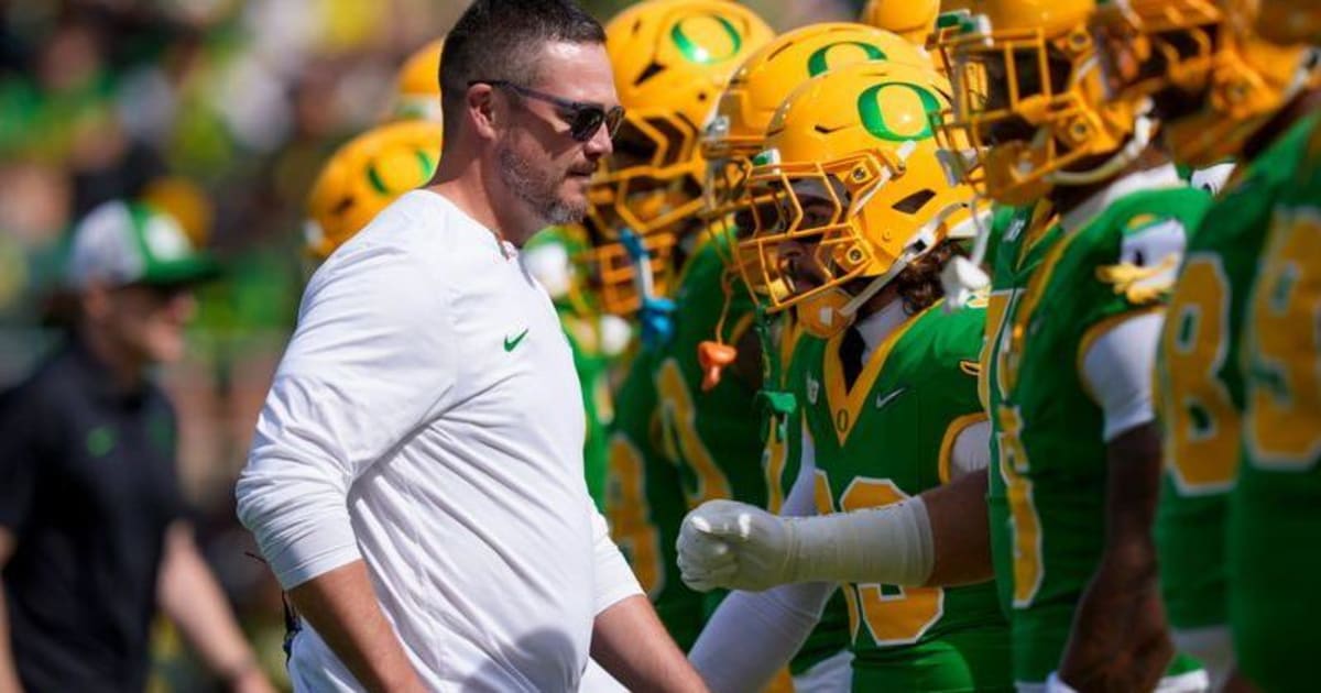 Oregon Ducks head coach Dan Lanning throwing football on College GameDay set