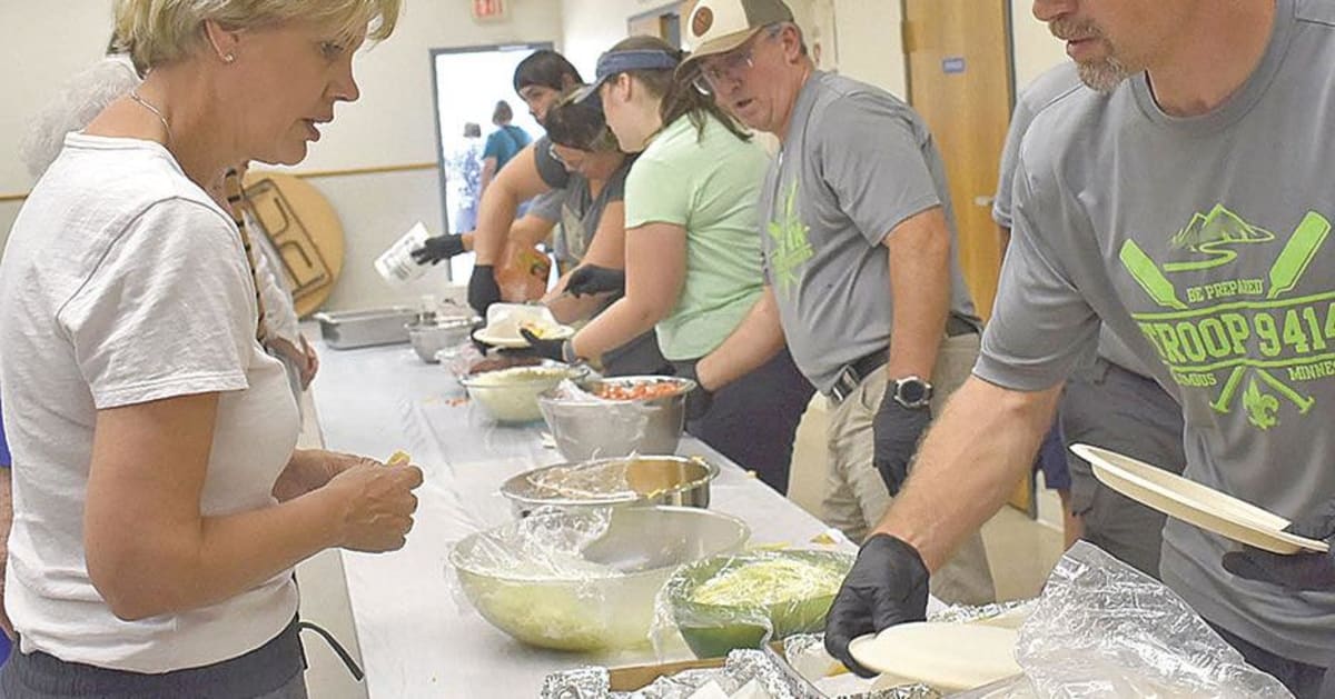 Volunteers setting up tents and tables at community festival in small Minnesota town