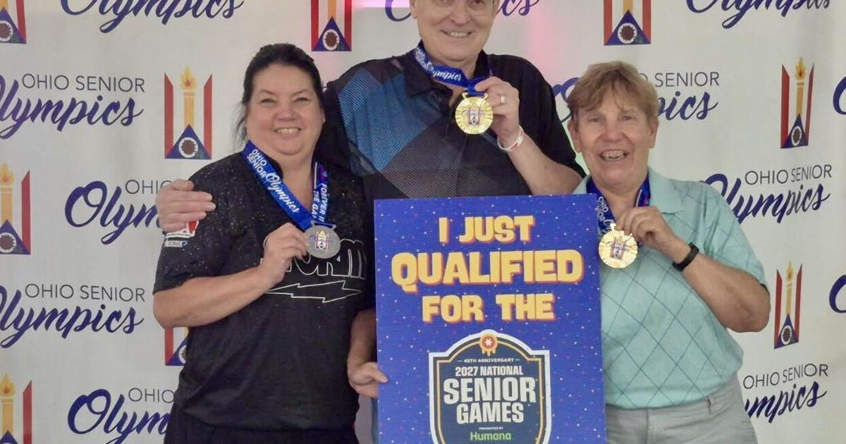 Three smiling women bowlers holding gold medals from Ohio Senior Olympics competition