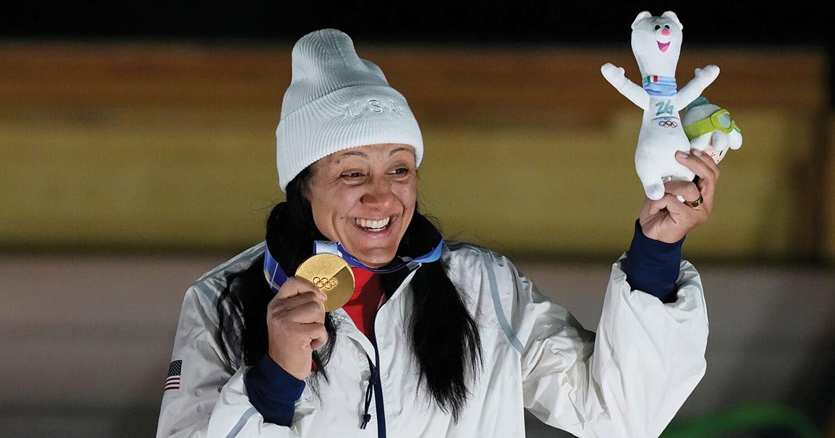 ** Elana Meyers Taylor waves to crowds during her New Braunfels parade holding Olympic gold medal