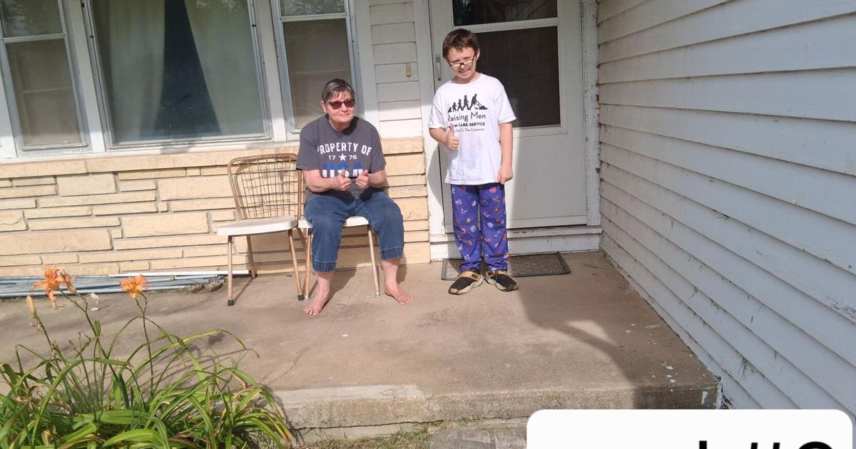 ** Young boy mowing elderly neighbor's lawn while father works on home repairs nearby