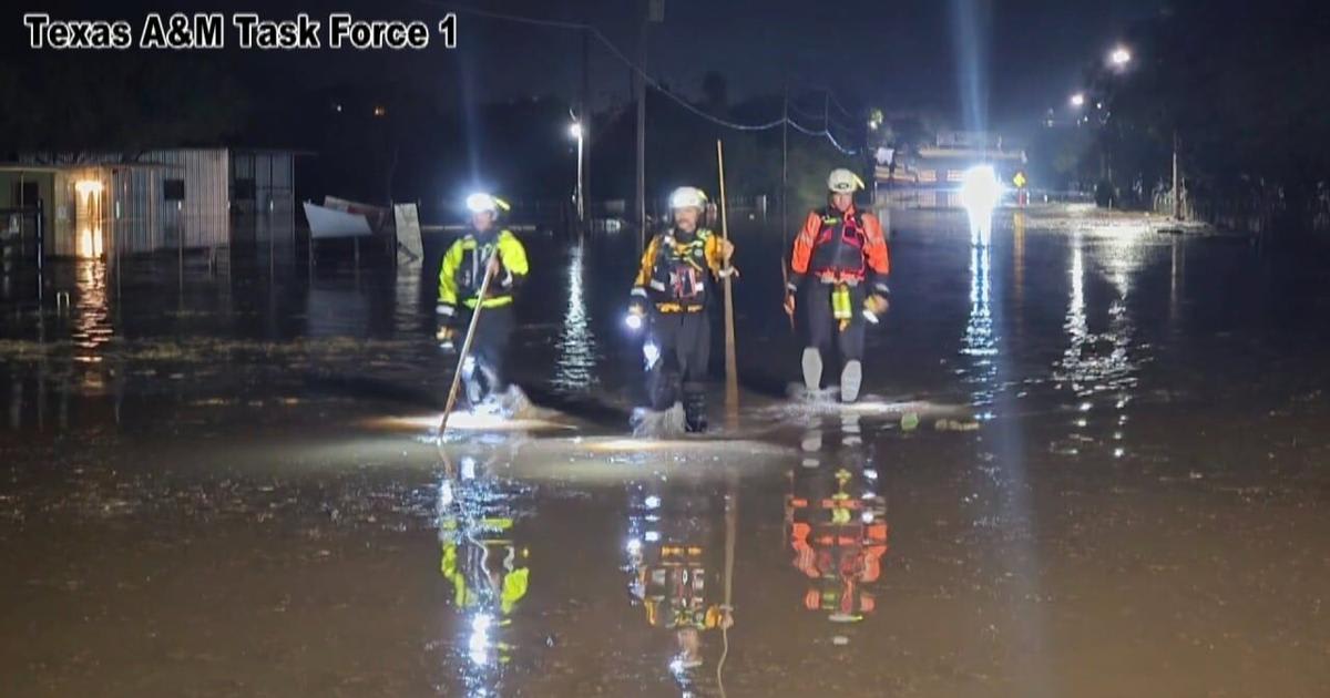 Gainesville firefighters navigating rescue boat through flooded Texas waters during deployment