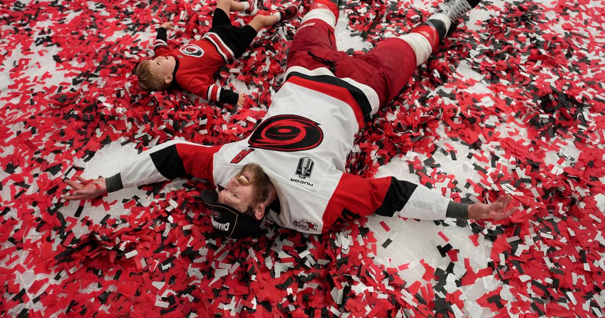 ** Carolina Hurricanes defenseman Jaccob Slavin celebrating on ice after winning Stanley Cup championship