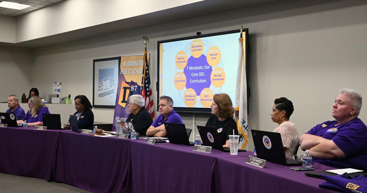 Bloomington District 87 board members wearing purple and gold D87 United shirts at school meeting