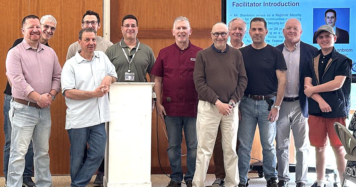 Community leaders and First Selectman standing with FBI agent Michael Shanbrom at synagogue breakfast event