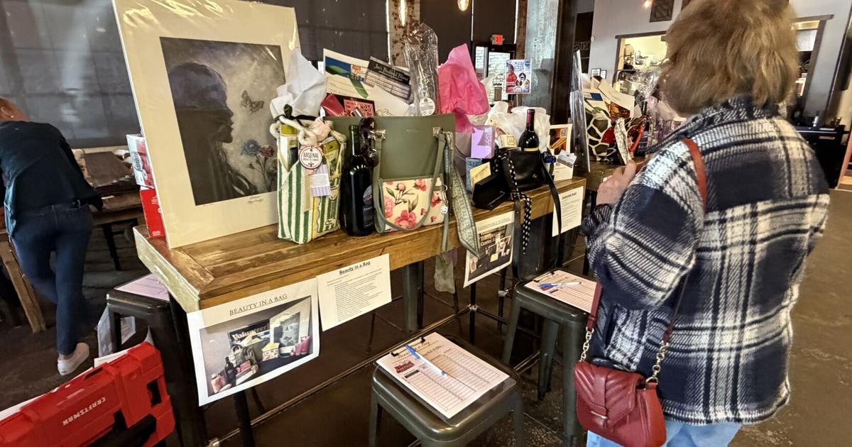 Designer handbags filled with jewelry and gifts displayed at Watertown charity auction fundraiser