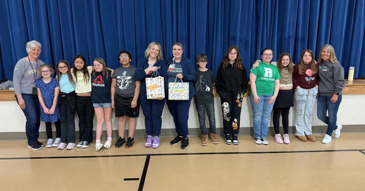 Riley Elementary Student Council members pose with Good Samaritan Hospital Foundation representatives holding donation