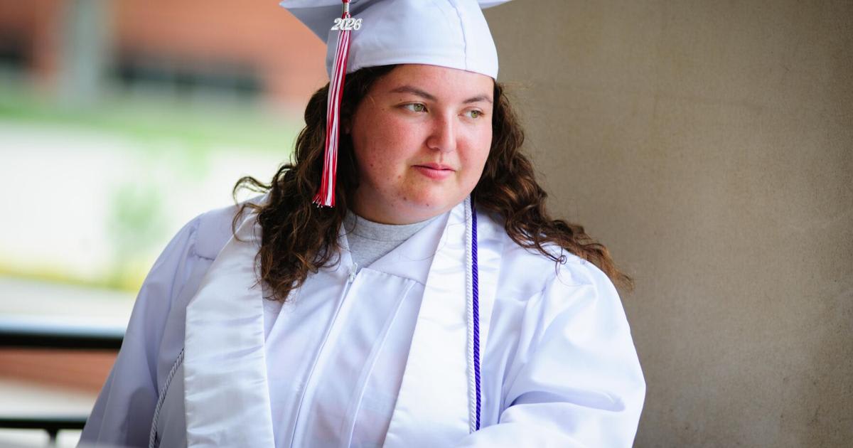 ** Vanoss High School graduates in red and white gowns preparing for commencement ceremony