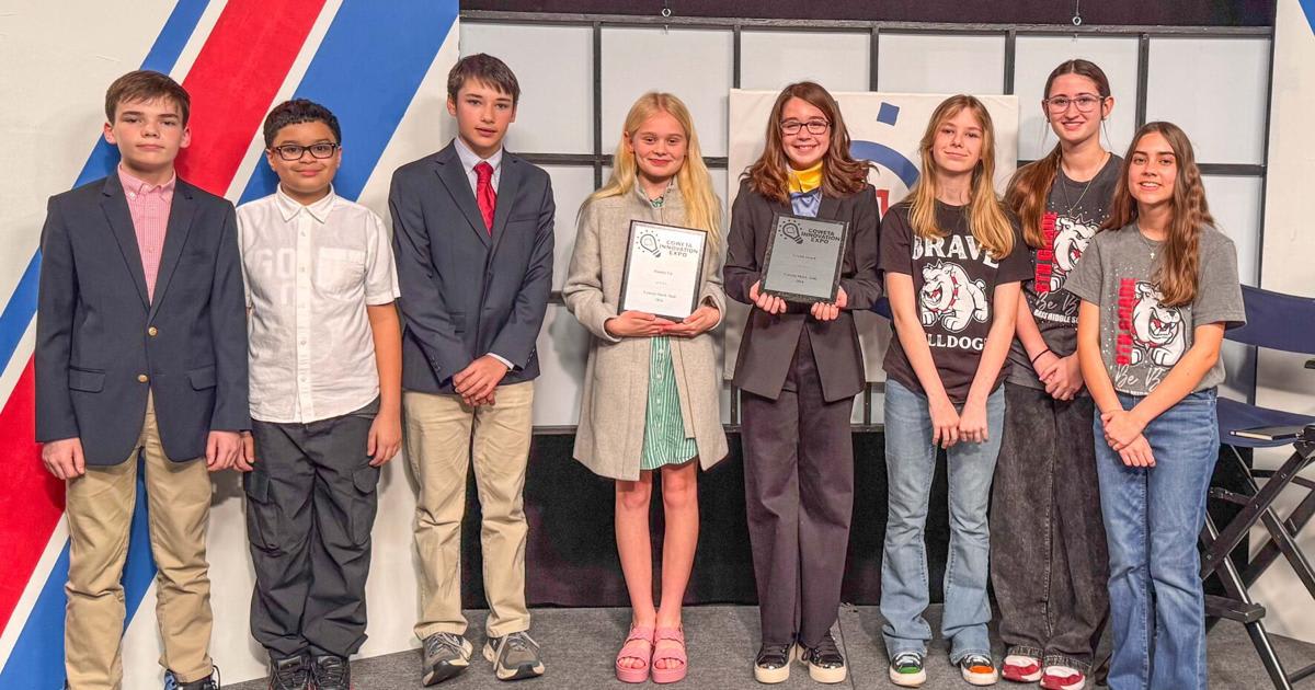 Middle school students and teachers pose with judges at Coweta Innovation Expo awards ceremony