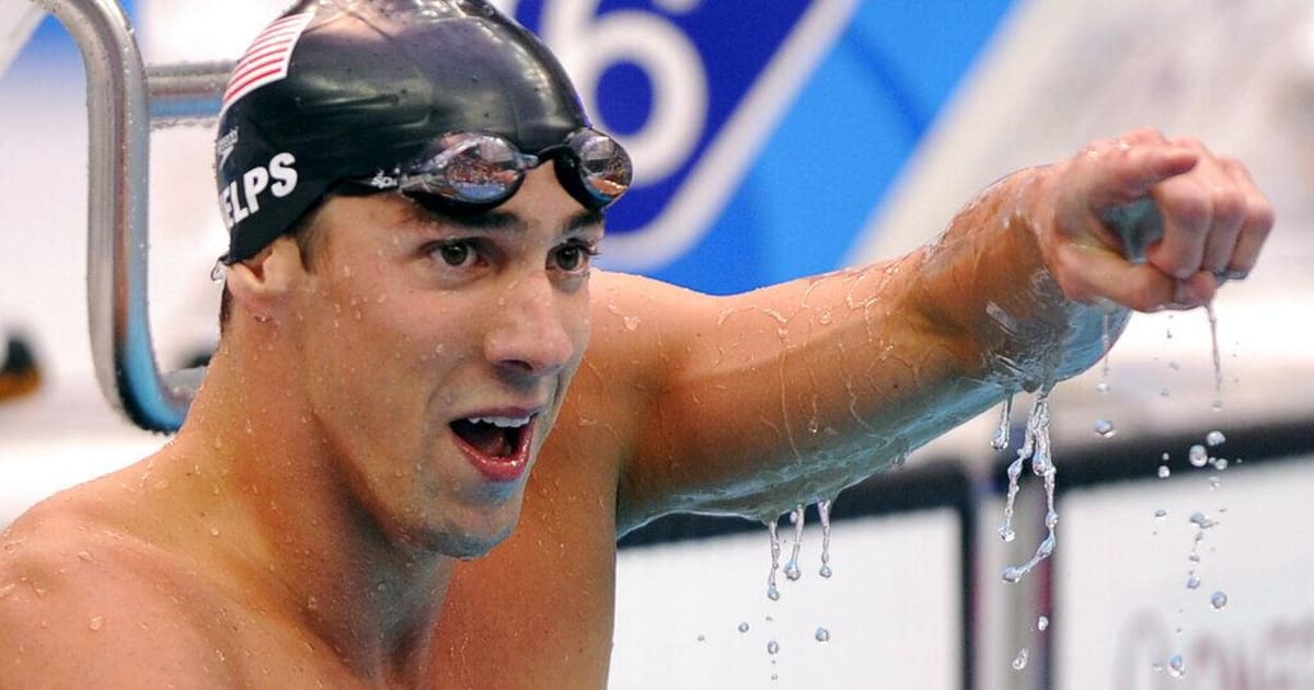 ** Michael Phelps celebrates with raised arms after winning gold medal in Beijing pool