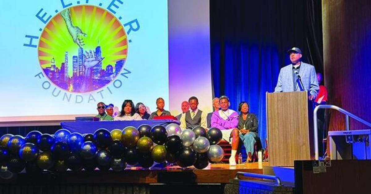 Stan Muhammad addresses students and families at I-CAN ceremony in Lancaster High auditorium