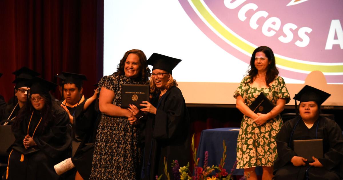 Graduate Alina Partch receives diploma from Principal Tracy Jaramillo at Success Academy graduation ceremony