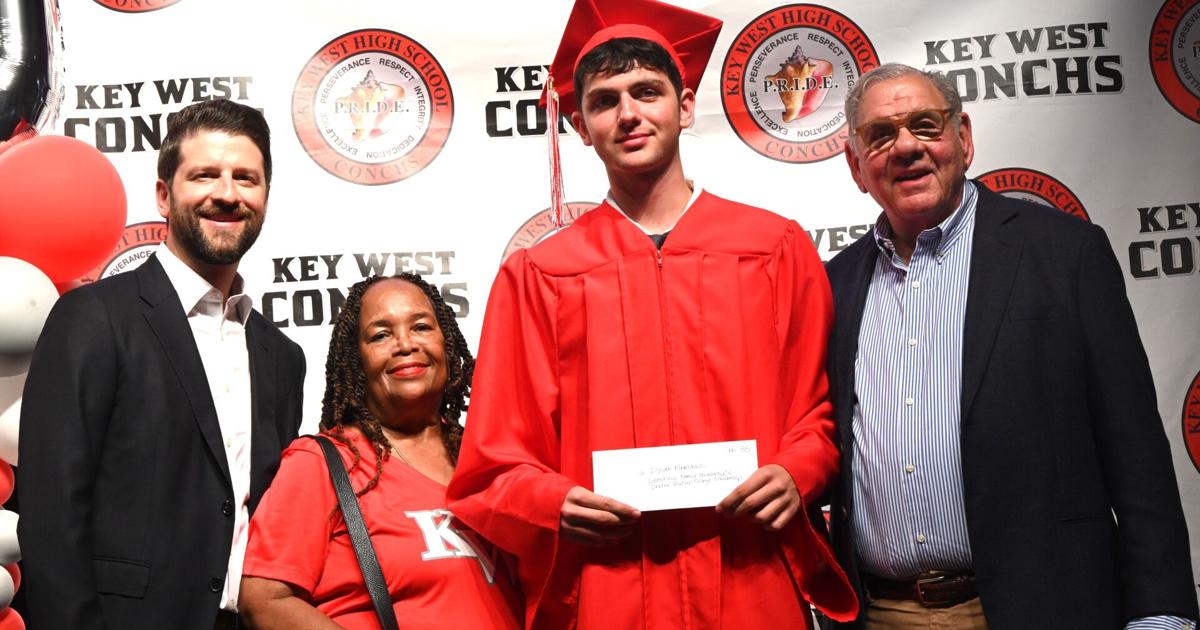 Dylan Martinez in graduation cap and gown holding scholarship award certificate