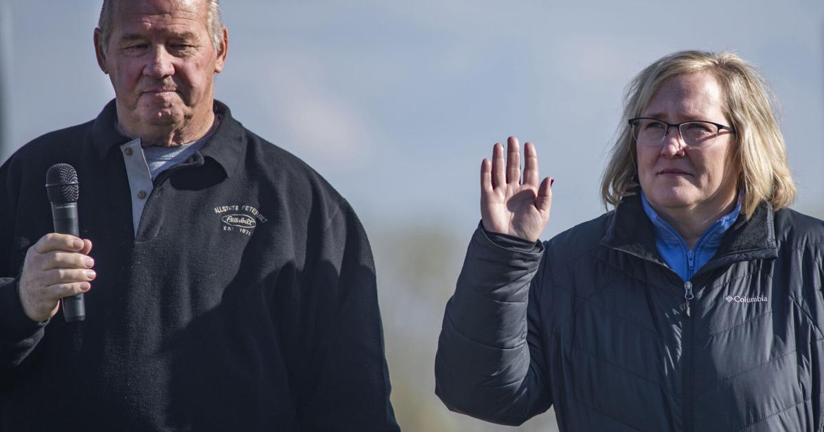 Twenty-year cancer survivor Jeanette Ward waves from truck leading survivor convoy at Iowa charity event