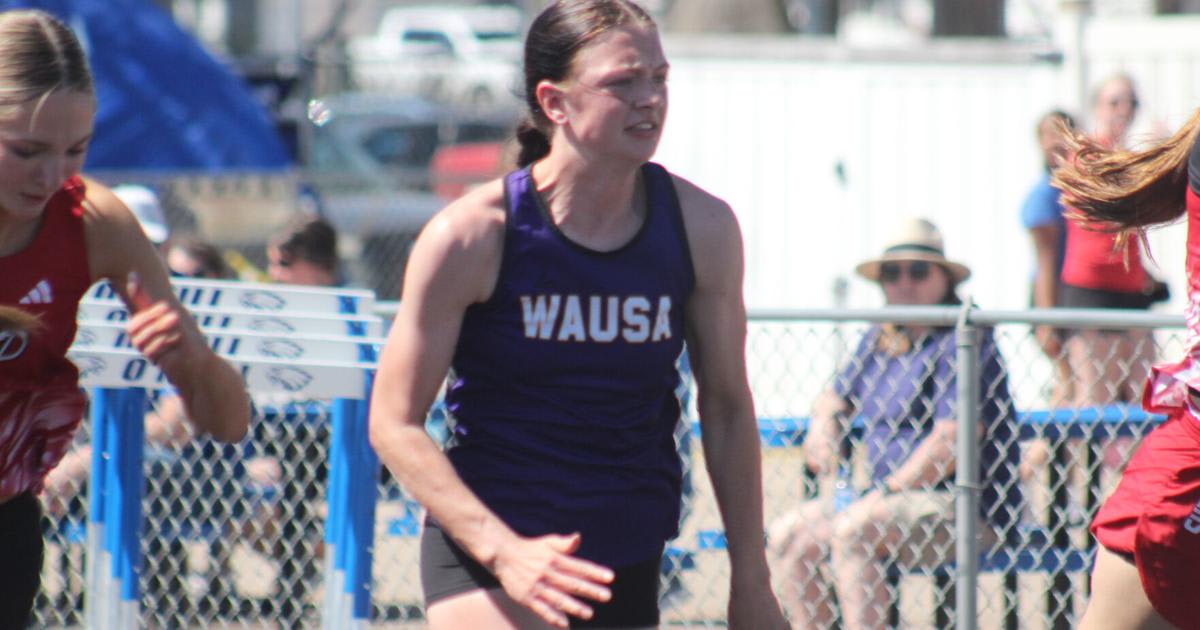 High school female athlete sprinting on outdoor track during competition meet