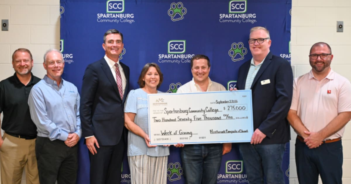 Spartanburg Community College president receives large ceremonial check from NorthMark representative