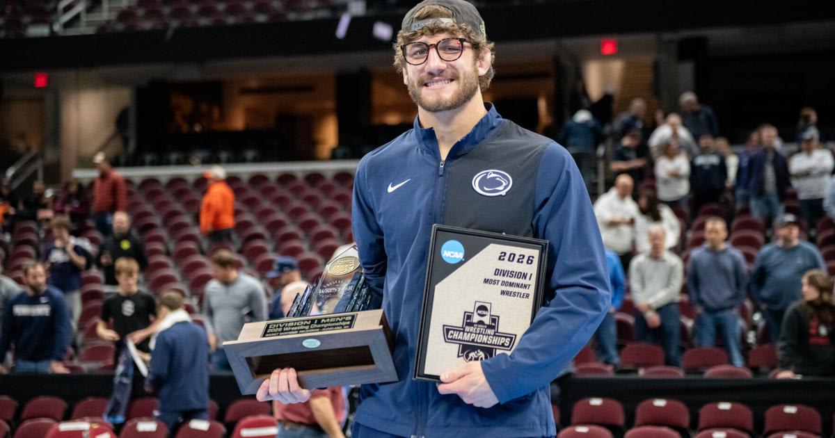 Mitchell Mesenbrink holding NCAA wrestling championship trophies after winning his second national title at Penn State