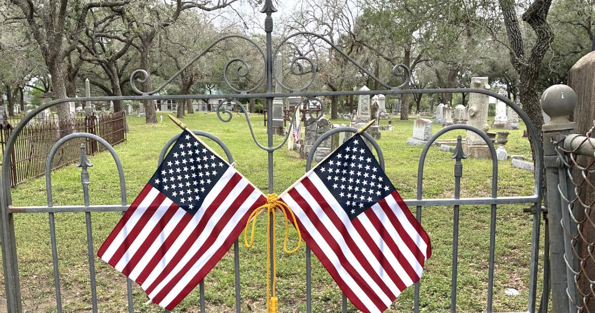 American flags placed on veteran graves at Oak Hill Cemetery in Goliad County Texas
