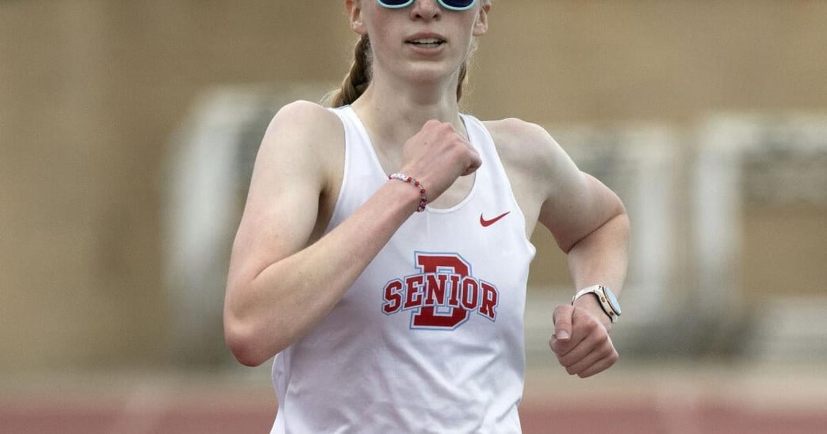 High school runner Emma Chesterman competing in 3,000 meter race at outdoor track meet