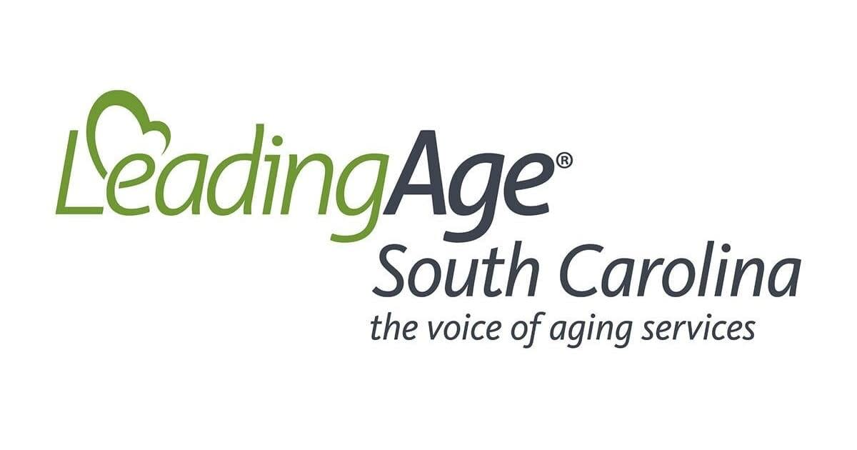 Caregiver assisting elderly resident in South Carolina nursing home facility with compassionate care