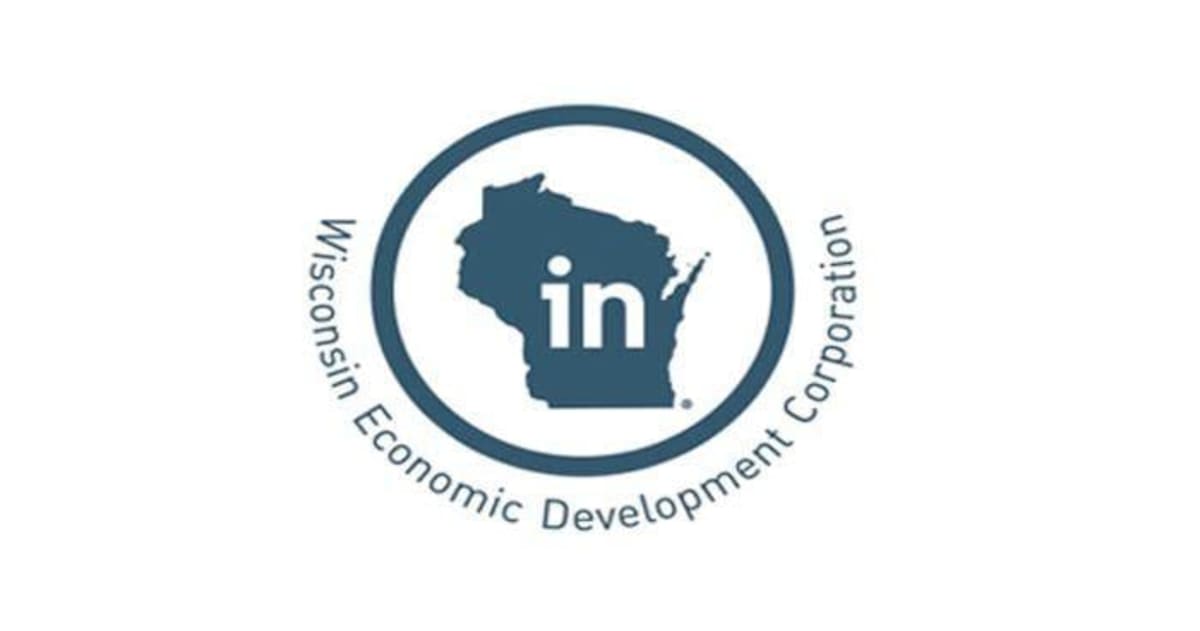 Modern biohealth manufacturing facility exterior with Wisconsin BioHealth Tech Hub branding and laboratory windows