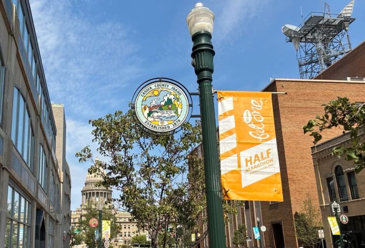 Colorful circular porcelain county seal mounted on downtown Boise street pole