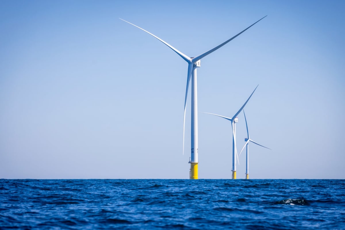 Offshore wind turbines standing in Atlantic Ocean waters off Massachusetts coast at sunset