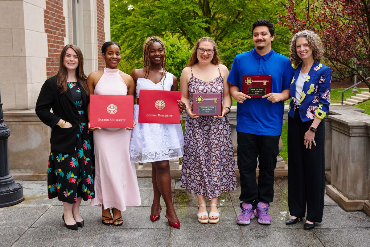Six Boston University Wheelock award recipients standing with Dean Penny Bishop at recognition ceremony