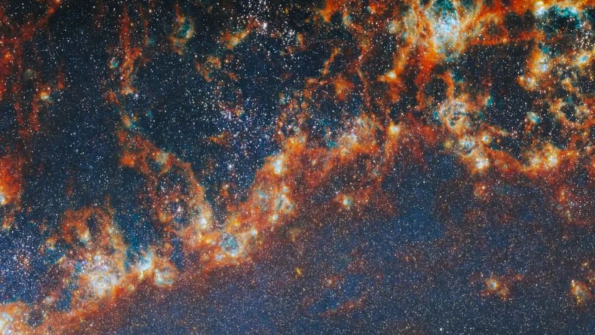 James Webb Space Telescope view of colorful star clusters emerging from glowing gas clouds