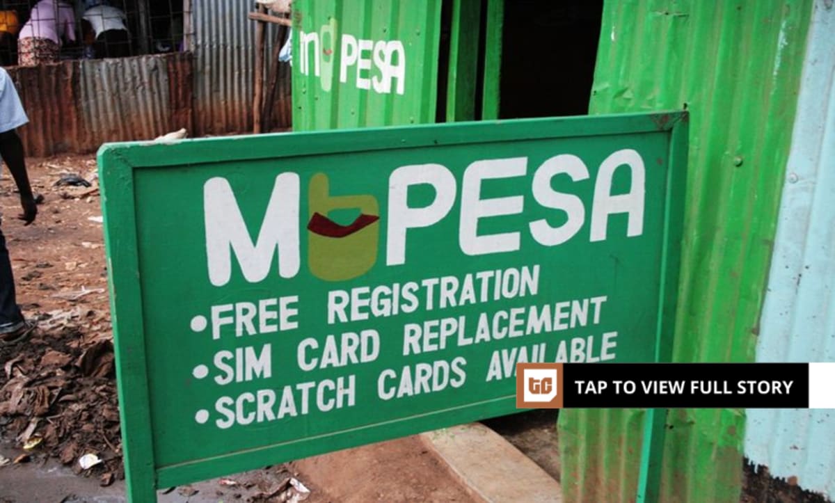 ** Kenyan people using mobile phones for M-PESA digital money transactions and payments