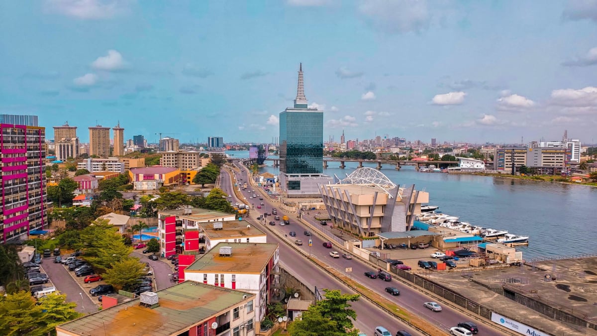 African business professionals reviewing tech investment documents in modern office setting
