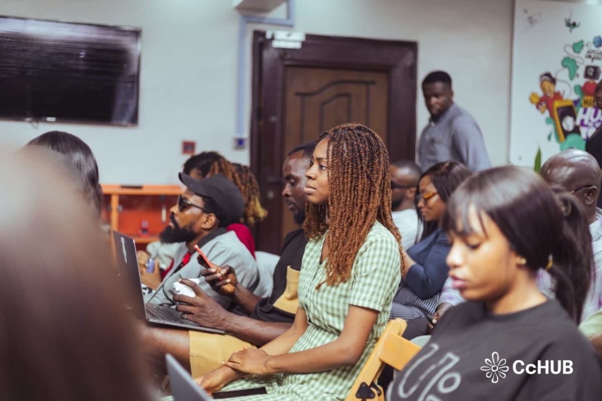 Young Nigerian students working on laptops in a bright modern training hub